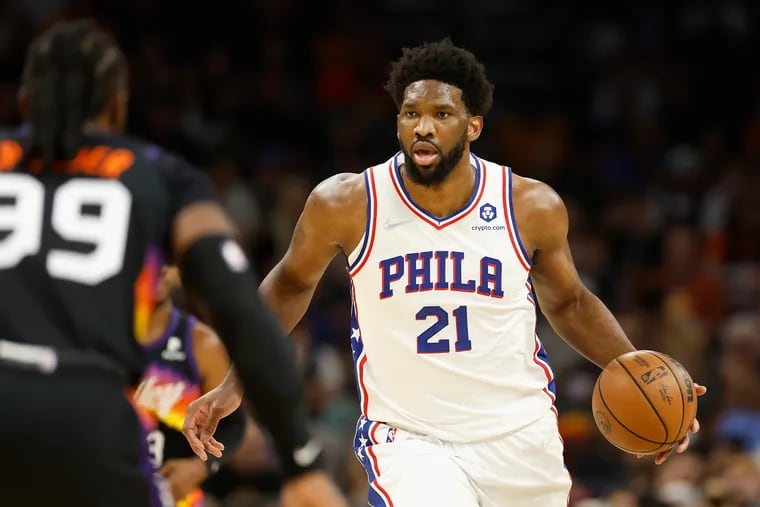 PHOENIX, ARIZONA - MARCH 27: Joel Embiid #21 of the Philadelphia 76ers handles the ball during the first half of the NBA game against the Phoenix Suns at Footprint Center.