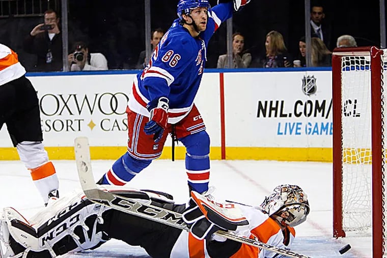 The Rangers' Chris Mueller celebrates after scoring a goal against Flyers goalie Steve Mason. (Jason DeCrow/AP)