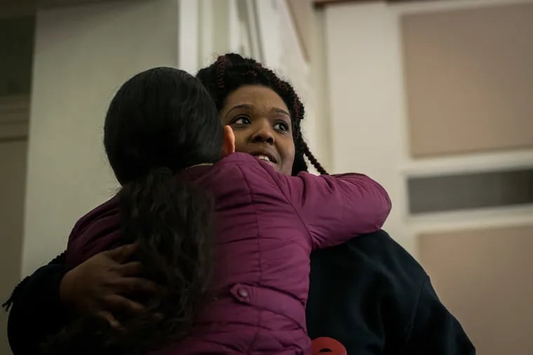 Nyzia Easterling (right) embraces a friend after hearing Camden City Council decide to take no action on the proposed ordinance to regulate makeshift memorials at a Council meeting on Tuesday, March 12, 2019.