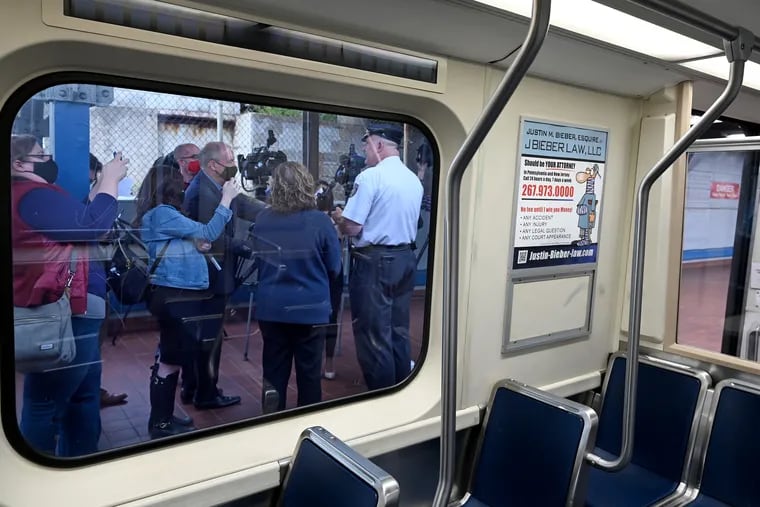 SEPTA Transit Police Chief Thomas Nestel III and SEPTA General Manager Leslie Richards are seen through the window of a trains as they hold a news conference on an El platform at the 69th Street Transportation Center on Oct. 18, following a brutal rape on a subway train.
