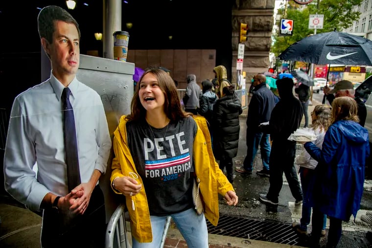 Allison Kinne, 21, a Penn student from Great Barrington, Mass. stops in front of a cardboard cutout of Mayor Pete Buttigieg as she arrives at the rally with her sister, Lauren Kinne, 18, a student at Haverford. Allison volunteered, "we're his biggest fans."