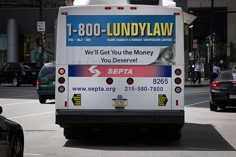 A SEPTA bus has a Lundy Law advertisement on its back side. Photograph taken along N. 15th St. at Market St. in Philadelphia on Tuesday, August 27, 2013. (ALEJANDRO A. ALVAREZ / STAFF PHOTOGRAPHER)
