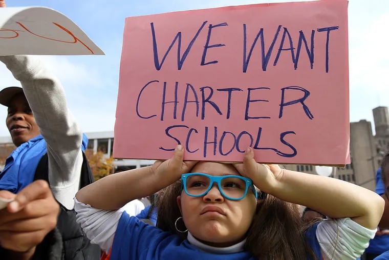 Adessa Lewis, a KEPA first-grader, holds up a sign in front of the Philadelphia schools administration building during a rally supporting new charter schools in Philadelphia on November 11, 2014. ( DAVID MAIALETTI / Staff Photographer )