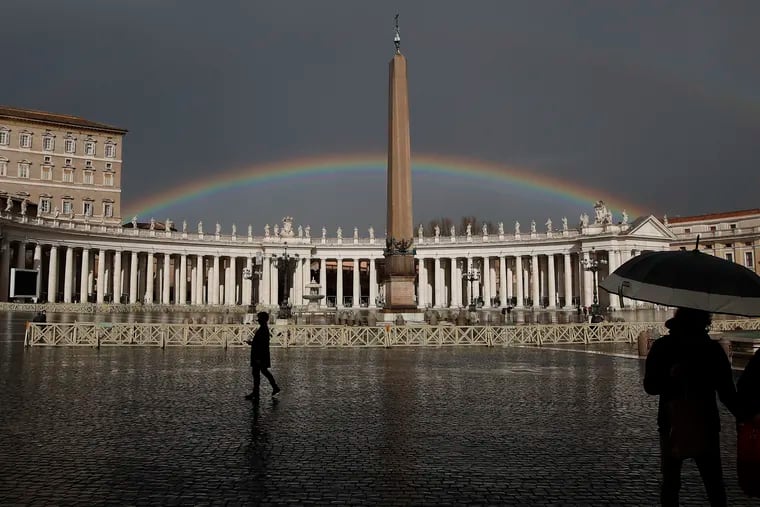 A rainbow shines over St.Peter's Square at the Vatican, on Jan. 31, 2021. A Vatican official has apologized to a leading Catholic LGBTQ advocacy group for having yanked a reference to it on the Vatican website.