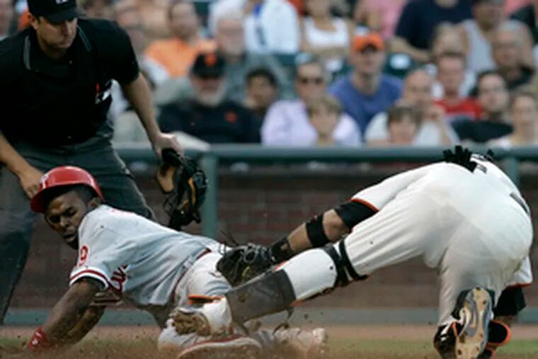 Phillies&#0039; Michael Bourn (left) avoids tag by Giants catcher Bengie Molina to score in seventh inning.