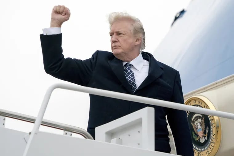 President Donald Trump gestures as he boards Air Force One at Andrews Air Force Base on Friday.