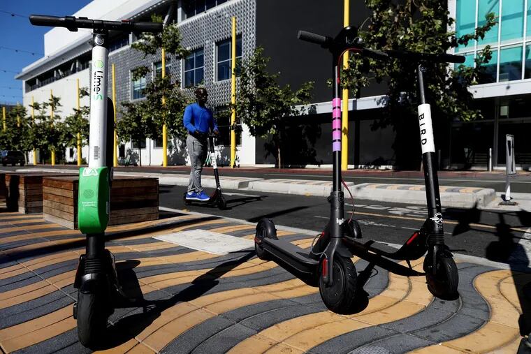 Electric scooters from Jump, Breeze Bike Share presented by Hulu, Bird, Lime and Lyft are on display.