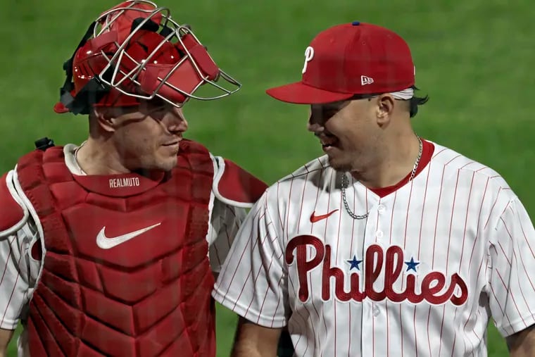 Phillies rookie Orion Kerkering is congratulated by catcher J.T. Realmuto after he pitched a scoreless eighth inning on Wednesday.