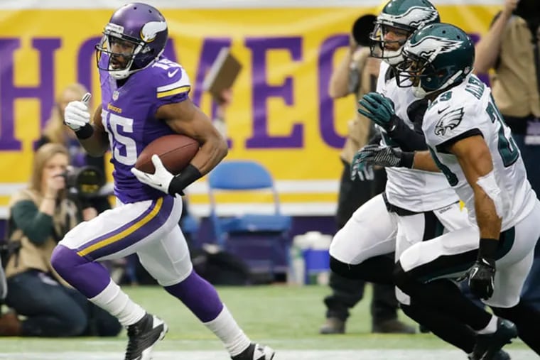 Vikings wide receiver Greg Jennings, left, runs from Philadelphia Eagles strong safety Nate Allen (29) during a 57-yard touchdown reception in the first half of an NFL football game, Sunday, Dec. 15, 2013, in Minneapolis. (Ann Heisenfelt/AP)