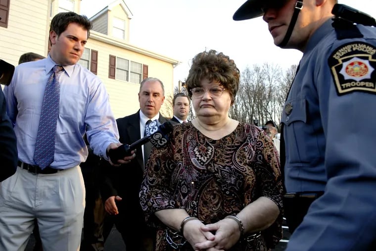Mary Jane Fonder, center, is escorted by a Pennsylvania State Trooper to her arraignment hearing in 2008. Fonder, 79, died Monday in prison. 