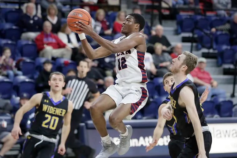 Penn’s Devon Goodman drives to the basket to score 2 of his 10 points in the Quakers' 105-57 win over Widener at the Palestra. Goodman also had 5 assists and 6 rebounds.