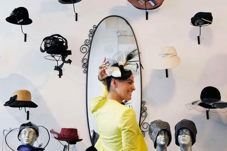Taylor Adami tries on a hat at Joan Shepp. There's a section for chic and crazy hats.