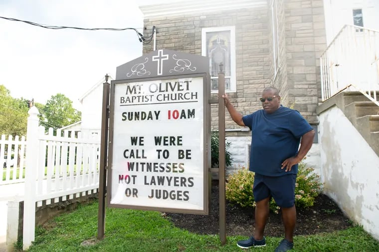 Malcolm Talton stands in front of Mount Olivet Baptist Church and Parsonage on Thursday, Aug. 17, 2023 in Haddonfield. Talton’s cousin, the Rev. Anthony Talton, has served as church pastor for 19 years after he succeeded his grandfather.