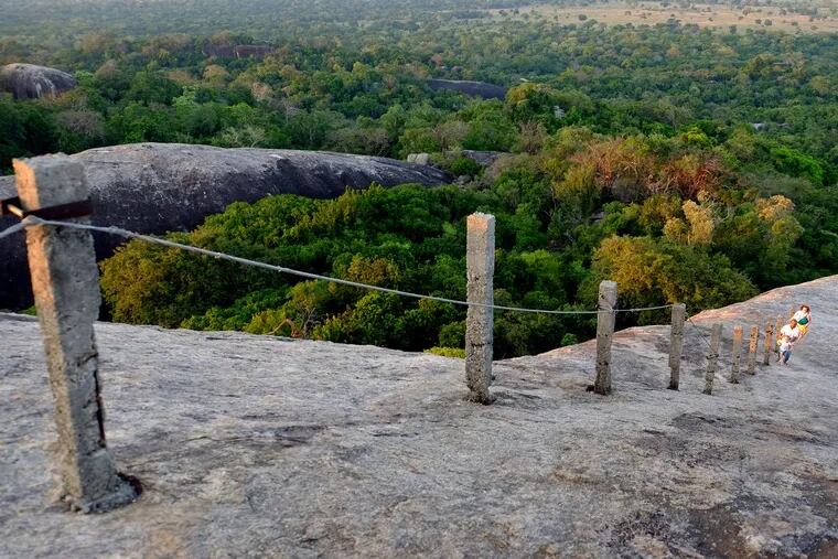 A hand rail guides visitors and pilgrims to the summit of Kudimbigala, an ancient forest hermitage south of Arugam Bay in eastern Sri Lanka.