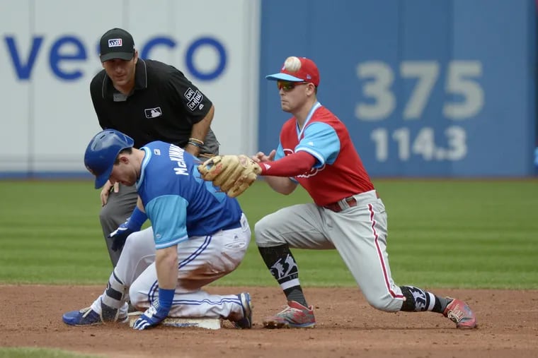 Toronto Blue Jays Billy McKinney (28) slides safely into second base with a double ahead of the tag by Philadelphia Phillies shortstop Scott Kingery during the third inning of a baseball game, Sunday, Aug. 26, 2018 in Toronto.