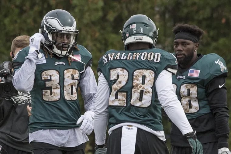 Newly acquired Eagles running back Jay Ajayi (left) walks past running backs Wendell Smallwood and Kenjon Barner during his first practice with the Eagles at the NovaCare Complex November 1, 2017. Ajayi was acquired in a trade with the Miami Dolphins.