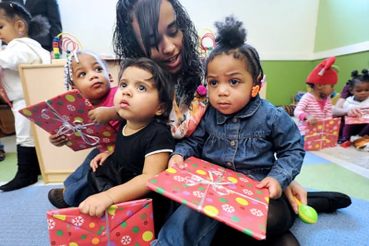 Teaching assistant Keilix Padilla with (from left) Destiny Boykin, Aurbrey Rodriguez, and Daizsha Snyder at the John S. and James L. Knight Early Learning Research Academy in Camden. (Sharon Gekoski-Kimmel / Staff Photographer)