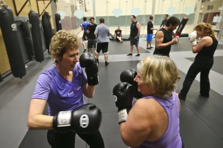 Julie Bruce, left, spars with Diane Crist during a Mixed Martial Arts based workout class called "Fight Shape" in Chanhassen, Minn., on Nov. 11, 2013. (Renee Jones Schneider/Minneapolis Star Tribune/MCT)