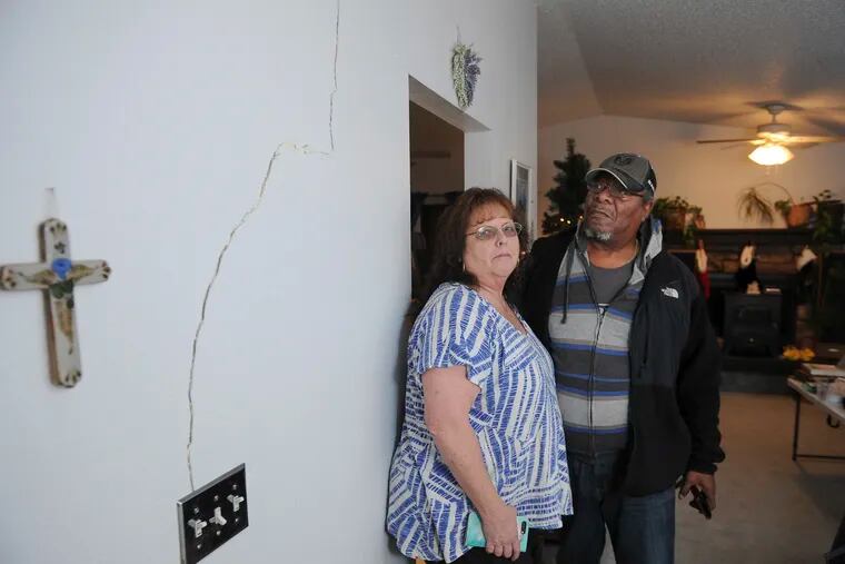 Al and Lyn Matthews show structural cracks in their home in south Anchorage, Alaska, following earthquakes Friday, Nov. 30, 2018. (AP Photo/Michael Dinneen)