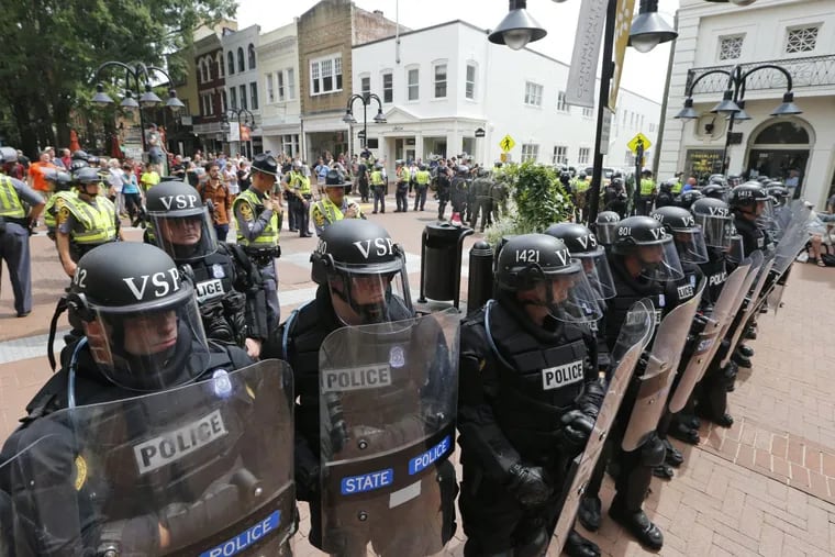 Virginia state police officers cordon off an area  in Charlottesville, Va., where a car ran into a group of protesters Aug. 12 after a white nationalist rally.