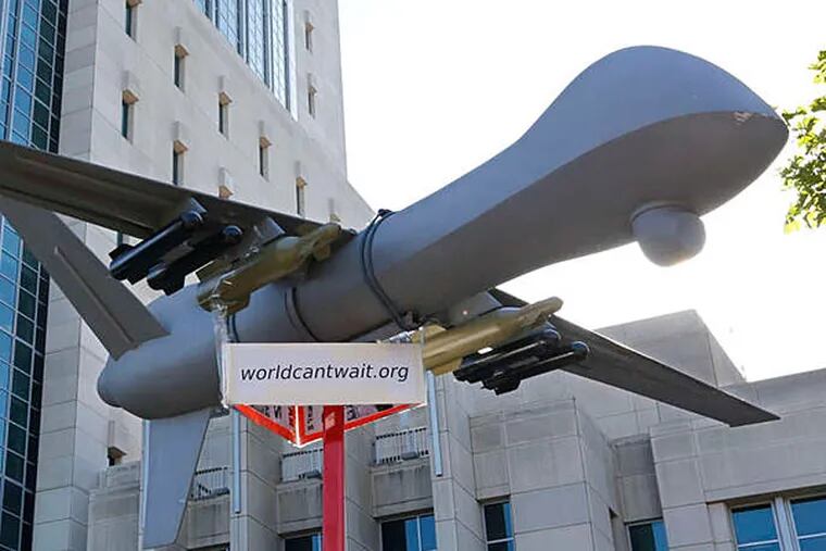 A scale model of a drone is displayed at a demonstration in Sacramento, Calif. Unlike some drones deployed overseas, domestic ones will not be armed. They do, however, raise concerns about safety and privacy. (AP)