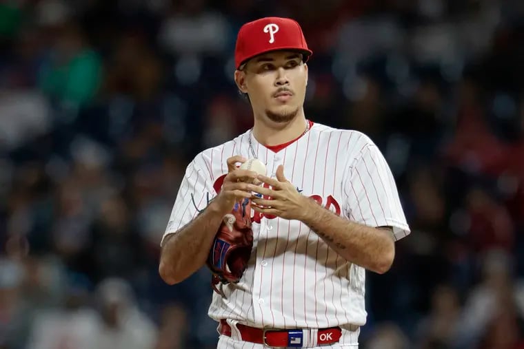 Phillies pitcher Orion Kerkering rubs a new baseball and looks towards the stands while pitching during the eighth inning of the New York Mets at Philadelphia Phillies MLB game at Citizens Bank Park in Philadelphia on Sunday, Sept. 24, 2023. It was Orion Kerkering’s major league debut.