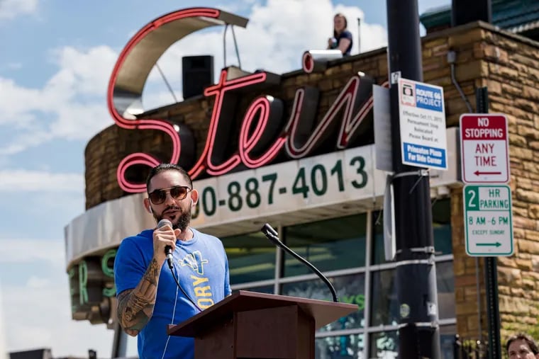 Jay Pross, owner of streetwear company Art History 101, addresses a crowd on the 7000 block of Frankford Avenue during the Mayfair 2nd Annual Arts Festival on April 13, 2019.