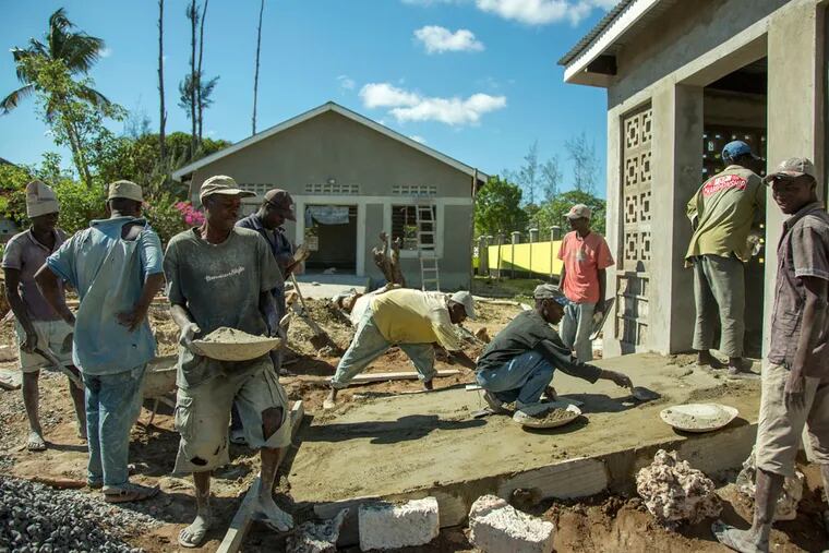Workmen prepare a concrete ramp for a building at the St. Francis Home in Malindi, Kenya. The home, with 13 buildings, will serve as a transitional shelter for sexually abused children. (Georgina Goodwin / For the Philadelphia Inquirer)