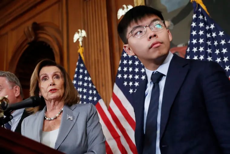 House Speaker Nancy Pelosi, left, with Hong Kong activist Joshua Wong and other members of Congress during a news conference on human right in Hong Kong on Capitol Hill in Washington, Wednesday, Sept. 18, 2019.
