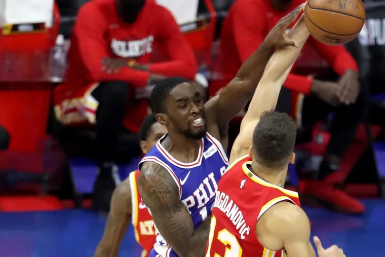 Shake Milton (center), passing around Atlanta's Bogdan Bogdanovich Tuesday, scored 14 points in a seven-minute span in Game 2. Joel Embiid knew Milton was due.