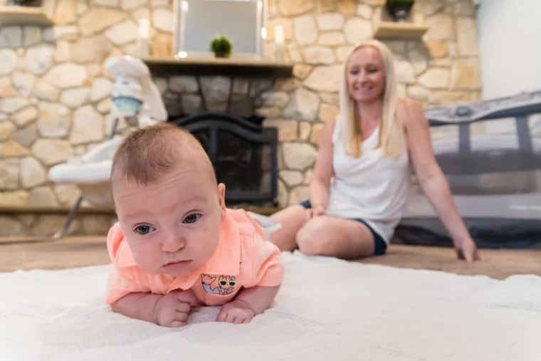 Patrick McFillin gets some tummy time on a blanket as his mother, Kim, looks on. Kim delivered Patrick after just 23 weeks and 3 days of pregnancy, a stage when most babies do not survive.