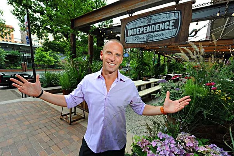 Michael Schulson, 41, is the owner of the new Independence Beer Garden, overlooking Independence National Historic Park (background) on 6th Street between Market and Chestnut Srs. opening July 15, 2014.    ( CLEM MURRAY / Staff Photographer )
