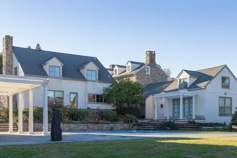 The home features several additions to the original stone building, including a wing with a large master bedroom suite, a separate carriage house and a standalone combination barn and pool house.