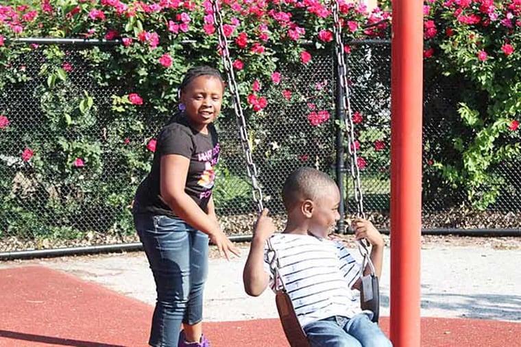 Kyle Thower gets a big push from cousin Nkyla on the swings at Mander Park, an area that is scheduled for renovations this month. Cindy A Stansbury / FOR THE DAILY NEWS