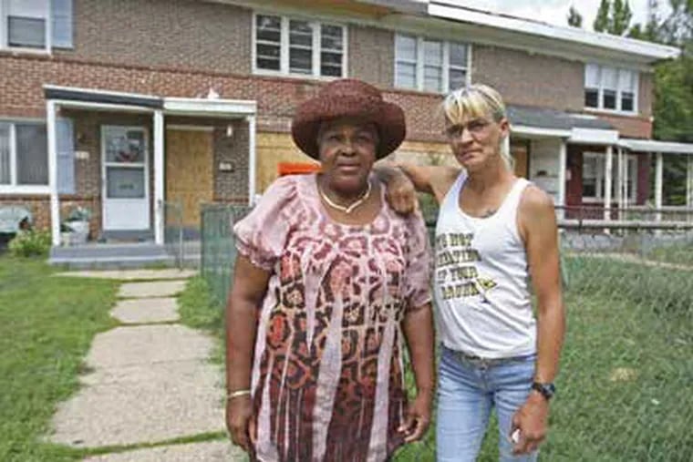 Joyce Curry (left) and Barbara Ramos each have a shuttered home on a side of their houses on North Martin Avenue. (Michael Bryant / Staff Photographer)