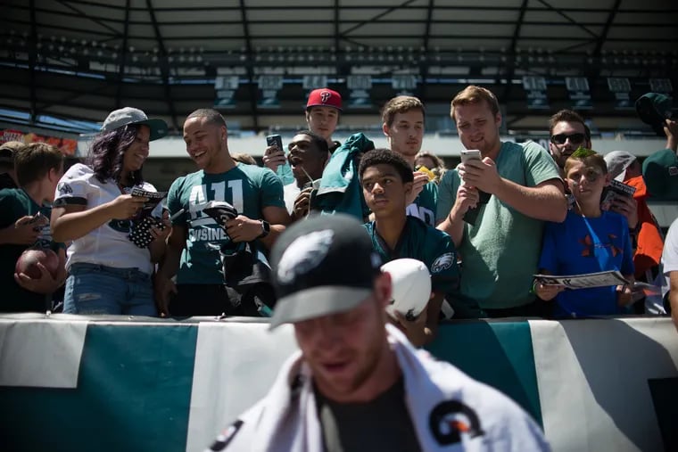 Eagles starting quarterback Carson Wentz signs jerseys, hats, footballs, and other paraphernalia for fans at Eagles training camp at Lincoln Financial Field on July 30th, 2017.