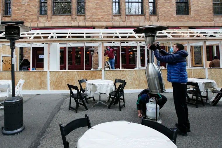 Workers prepare outdoor dining at the restaurant Parc in Rittenhouse Square on Thursday, November 19, 2020.  Center City restaurants are preparing for renewed coronavirus restrictions beginning at 5 p.m. Friday.