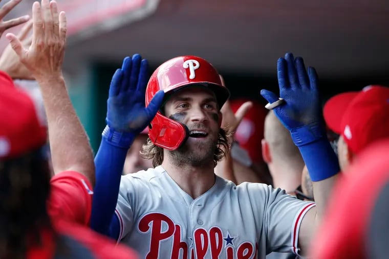 Bryce Harper celebrates his two-run home run during the eighth inning of the Phillies' win against the Cincinnati Reds on Monday afternoon.