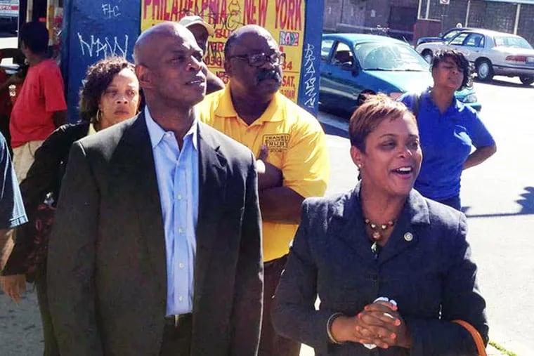 Councilwoman Cindy Bass, right, and state Rep. Stephen Kinsey chat with representatives of city agencies and community stakeholders at Broad Street and Olney Avenue after a walk-through of the business corridor Friday, Sept. 6. Bass and Kinsey are heading up a coordinated effort to improve the area. (Morgan Zalot / Daily News Staff)