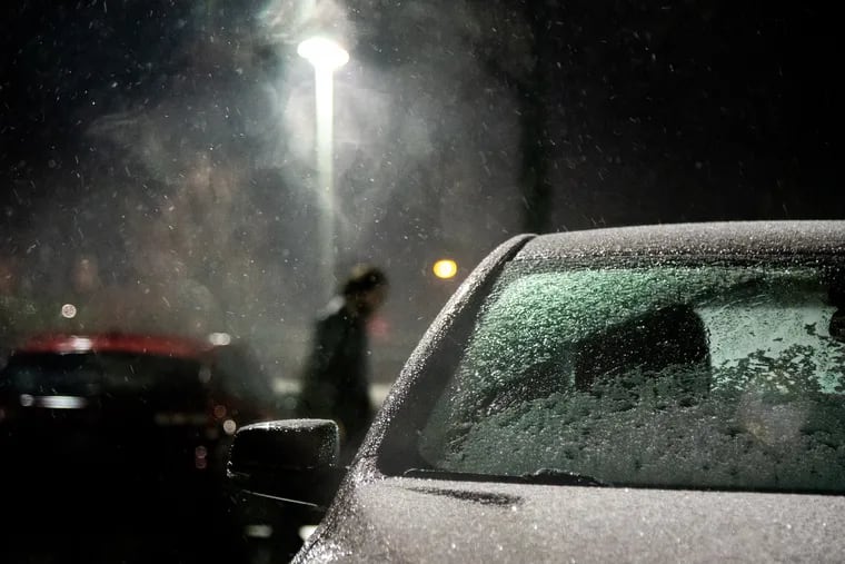 Precipitation falls on cars in a parking lot on City Avenue in the evening Jan. 7, 2020.