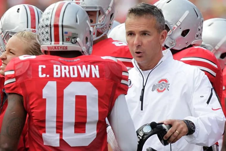 Ohio State head coach Urban Meyer talks to his team on the sidelines against Florida A&M during an NCAA college football game Saturday, Sept. 21, 2013, in Columbus, Ohio. (Jay LaPrete/AP)