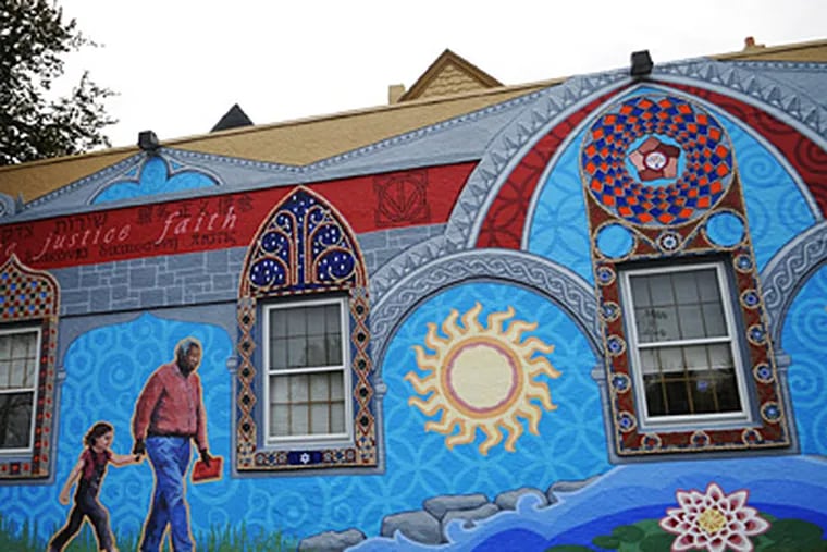 The mural is painted and tiled on the side of the Neighborhood
Interfaith Movement building on Germantown Avenue. (Kriston J. Bethel / Staff)