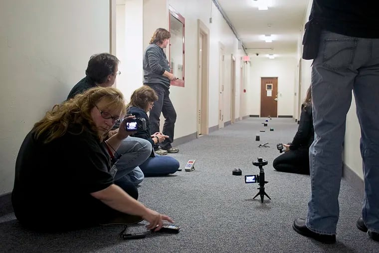 Members of the South Jersey Ghost Researchers monitor equipment and wait for any signs of paranormal activity at Camden City Hall on November 7, 2014. (Randi Fair/Staff Photographer)