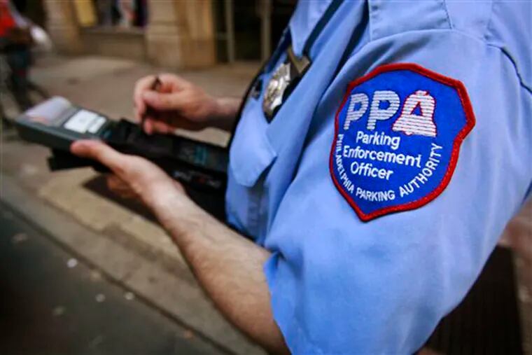 A member of the Philadelphia Parking Authority writes a ticket for an expired meter in Center City. It seems like almost everyone in Philadelphia has a close friend or family member working there.