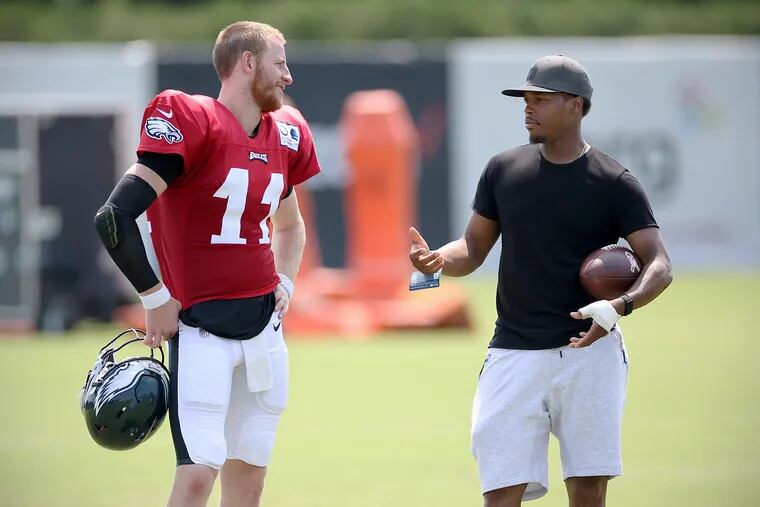 Quarterback Carson Wentz, left, talks with Toronto Raptors guard and Philadelphia native Kyle Lowry after Eagles training camp at the NovaCare Complex in South Philadelphia on Saturday, July 27, 2019.