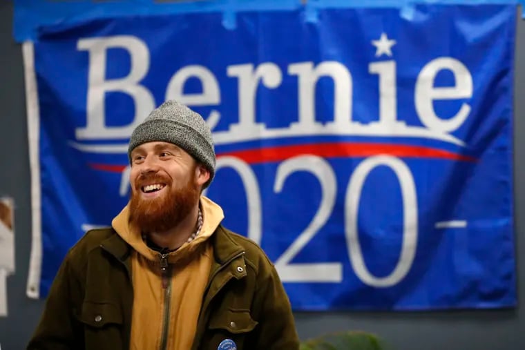 In this March 3, 2020, photo, Jonah Hahn, a supporter of Democratic presidential candidate Sen. Bernie Sanders, I-Vt., watches returns during a Super Tuesday watch party in Ann Arbor, Mich. (AP Photo/Paul Sancya)