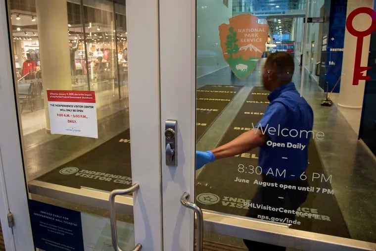 A maintenance worker locks the doors of the Independence Visitor Center at 5 p.m. last Wednesday.
