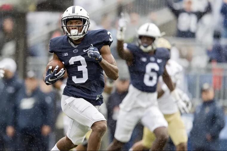 Penn State wide receiver DeAndre Thompkins (left) returns a punt for a touchdown against Akron at Beaver Stadium.