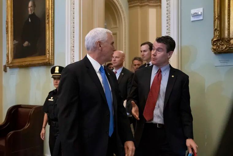 Vice President Mike Pence, left, talks with Sen. Todd Young, R-Ind., as they enter a Senate Republican policy luncheon at the Capitol in Washington, Tuesday, May 14, 2019. (AP Photo/J. Scott Applewhite)