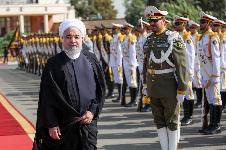In this photo released by the official website of the office of the Iranian Presidency, President Hassan Rouhani reviews an honor guard at the Mehrabad airport while leaving Tehran, Iran, for New York to attend United Nations General Assembly, Monday, Sept. 23, 2019.
